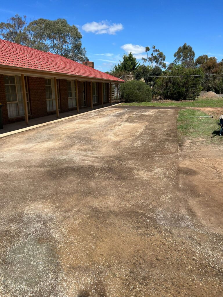 This is a photo of a driveway that has been dug out and is just about to have an asphalt driveway installed.